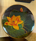 Decorative box with a yellow flower design on a wooden surface